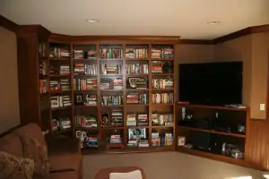 photo of a huge wood bookshelf in a den of a house
