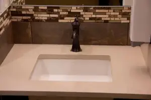 photo of a bathroom sink that has a black faucet